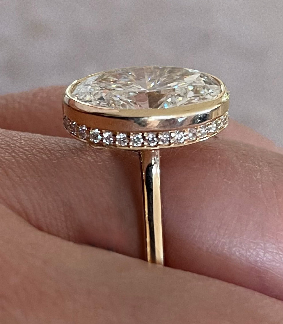 The Shae - 5.5ctw Oval Lab Grown Diamond Bezel Ring with a Peekaboo Halo