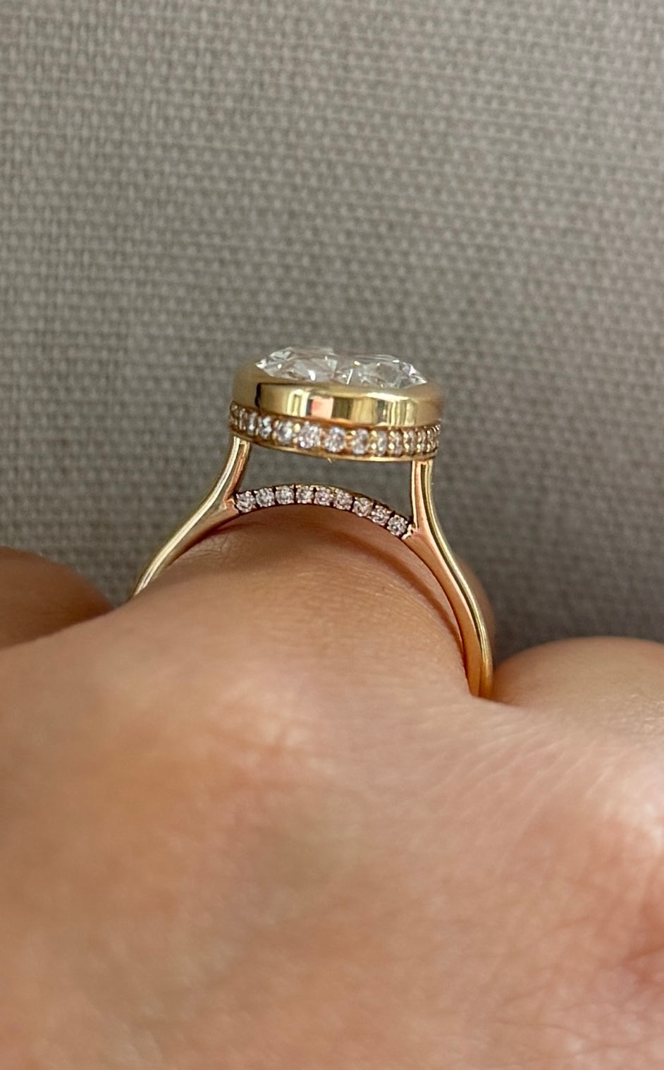 The Shae - 5.5ctw Oval Lab Grown Diamond Bezel Ring with a Peekaboo Halo