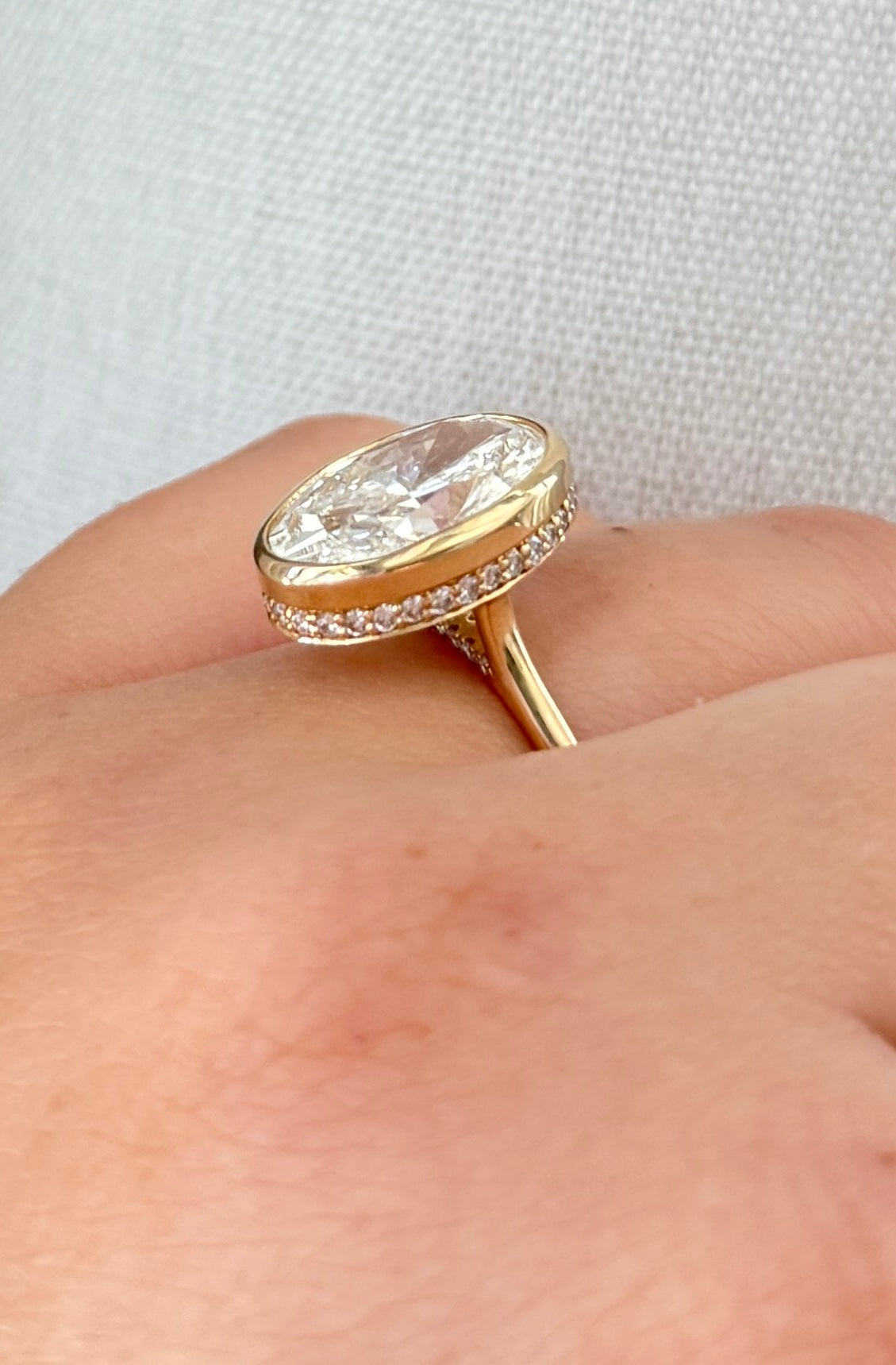 The Shae - 5.5ctw Oval Lab Grown Diamond Bezel Ring with a Peekaboo Halo