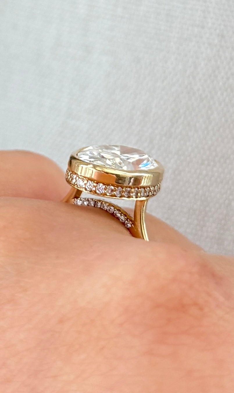 The Shae - 5.5ctw Oval Lab Grown Diamond Bezel Ring with a Peekaboo Halo