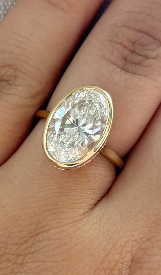The Shae - Size 7 - 5.86ctw Oval Lab Grown Diamond Bezel Ring with a Peekaboo Halo