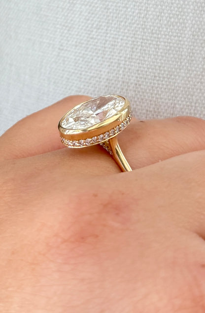 The Shae - 5.5ctw Oval Lab Grown Diamond Bezel Ring with a Peekaboo Halo
