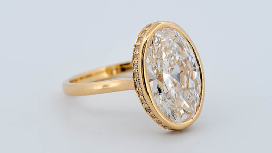 The Shae - Size 7 - 5.86ctw Oval Lab Grown Diamond Bezel Ring with a Peekaboo Halo